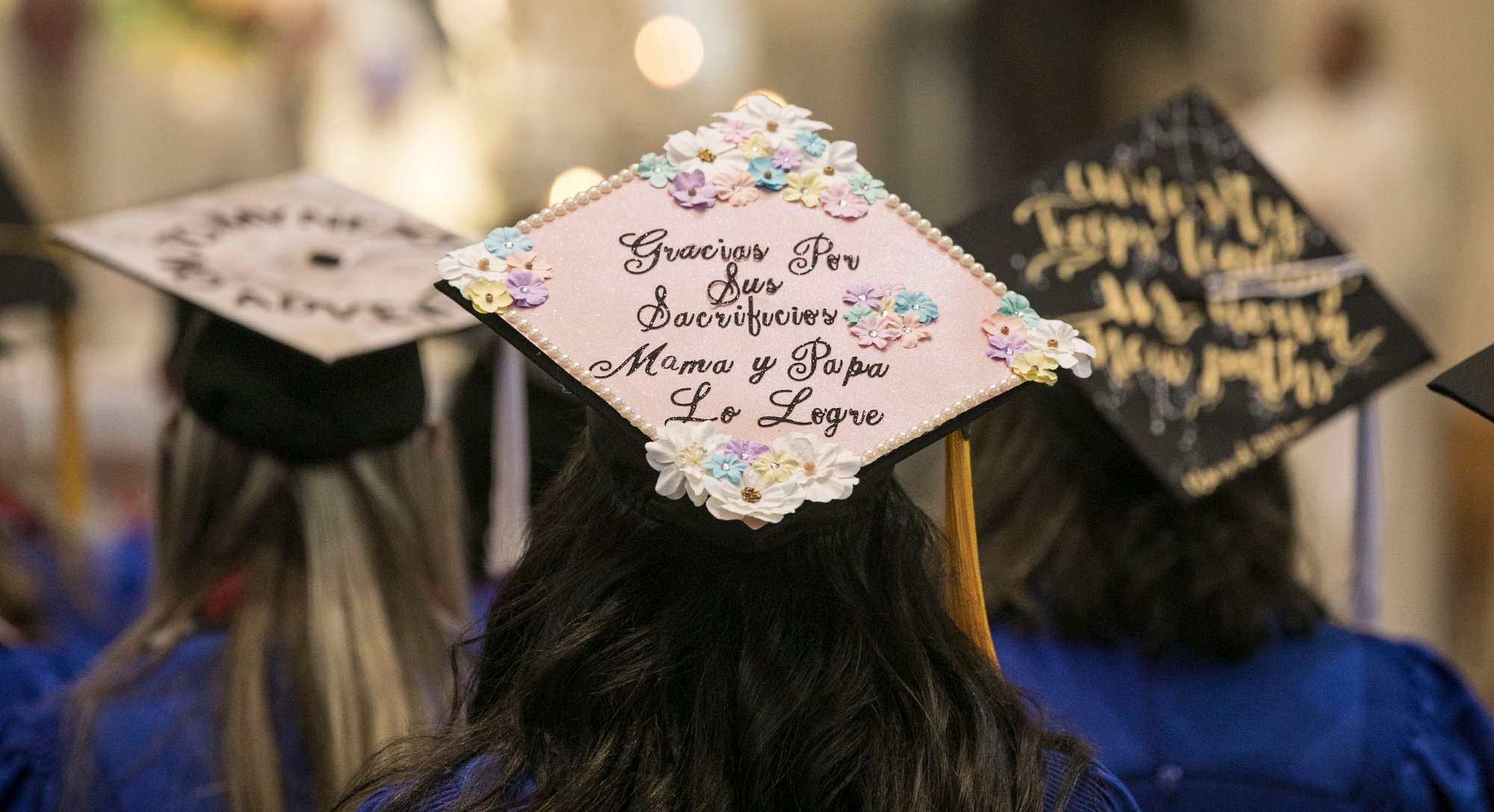  Students wearing decorated mortar boards gather with their fellow students, friends and family members inside the St. Vincent de Paul Parish Church for the annual Baccalaureate Mass. (DePaul University/Jamie Moncrief)